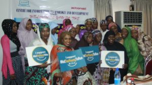 Female participants at the debate holding placards of the #NotTooYoungToRun campaign posed for a group photo shortly after the event
