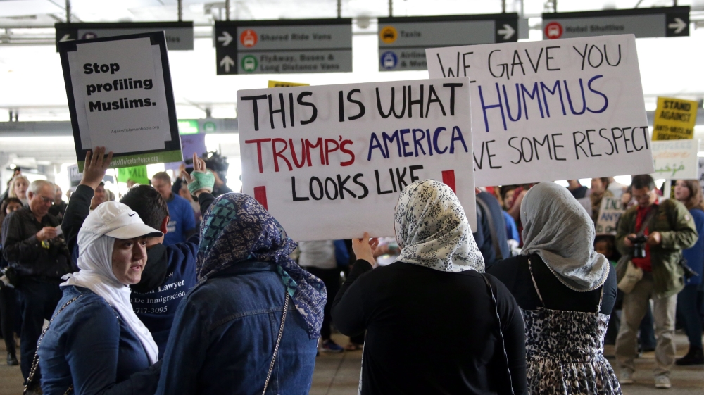 Trump signs new Muslim travel ban excluding Iraq US president signs order after courts blocked previous directive, with latest list of banned countries narrowed to six.