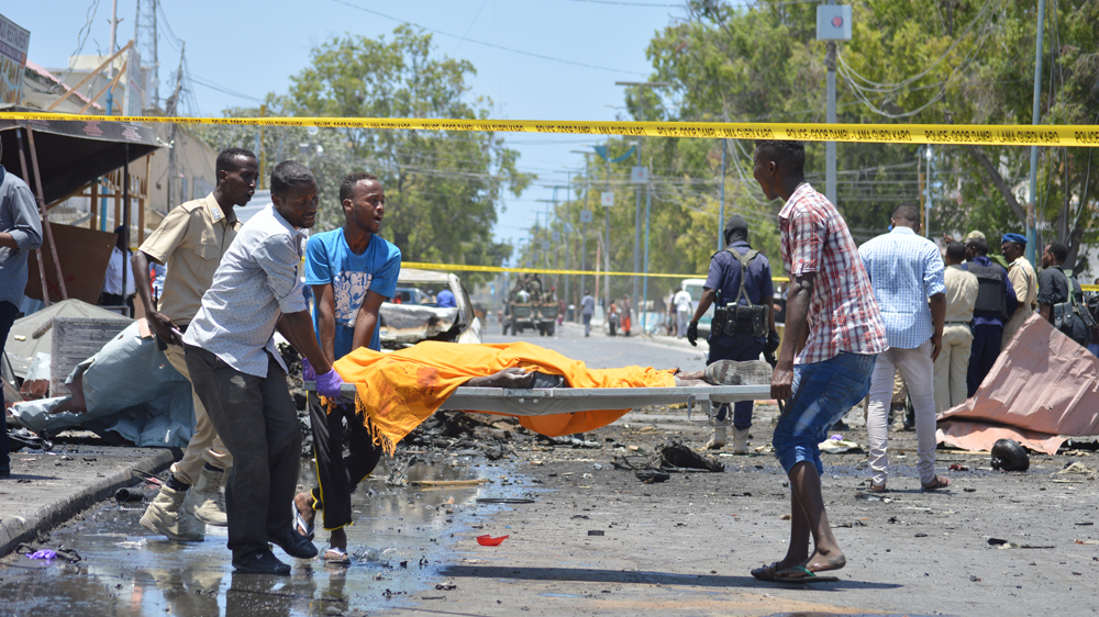 A massive blast outside a coffee shop in Somalia's capital kills at least seven as a series of attacks continues.