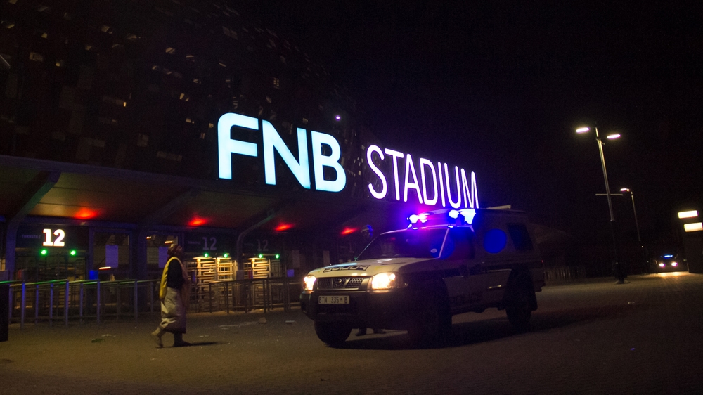Several others also injured when fans tried to get into the stadium that hosted the 2010 World Cup final, say police.